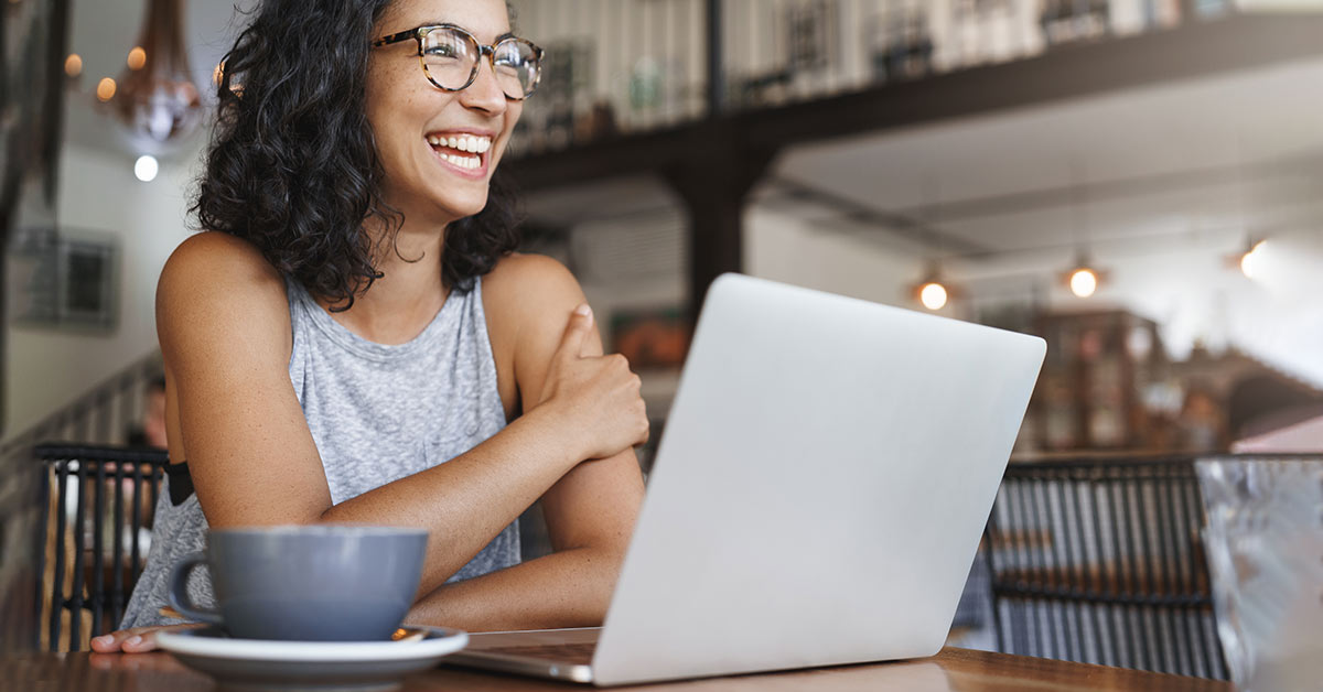 smiling woman using laptop