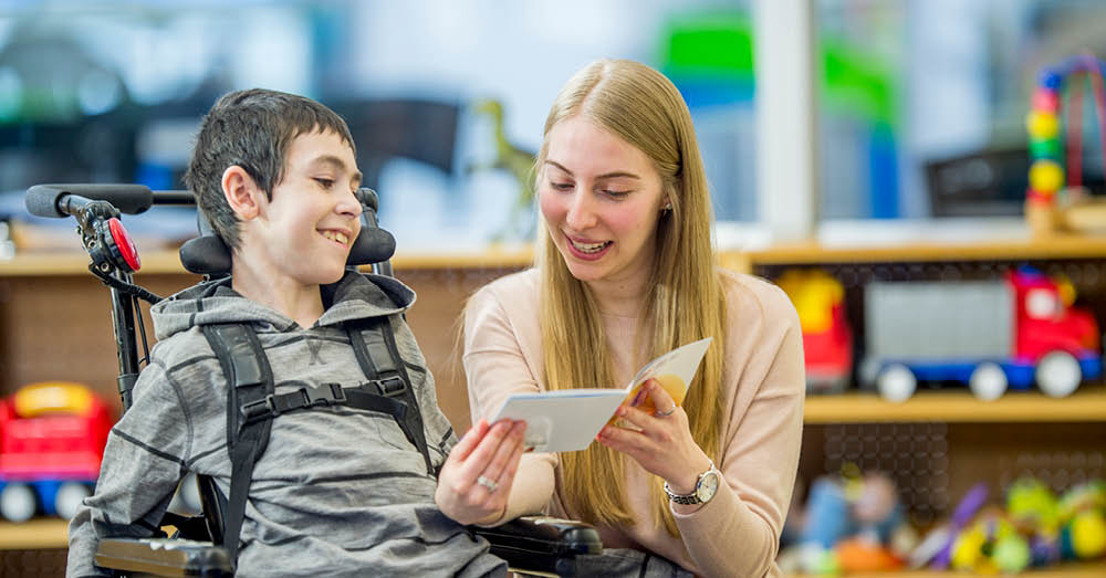 Woman helping child in wheelchair