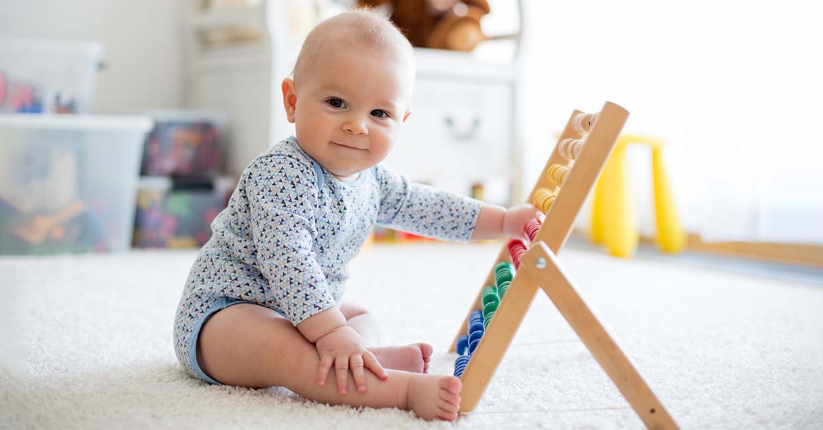 baby playing with abacus