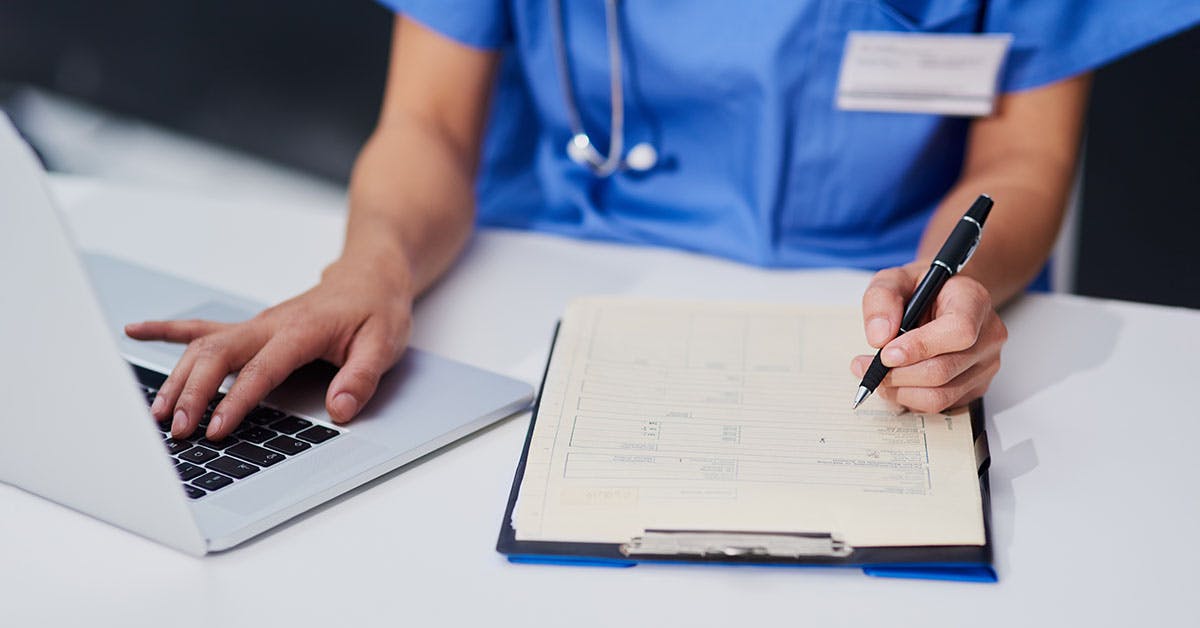 healthcare worker filling out paperwork