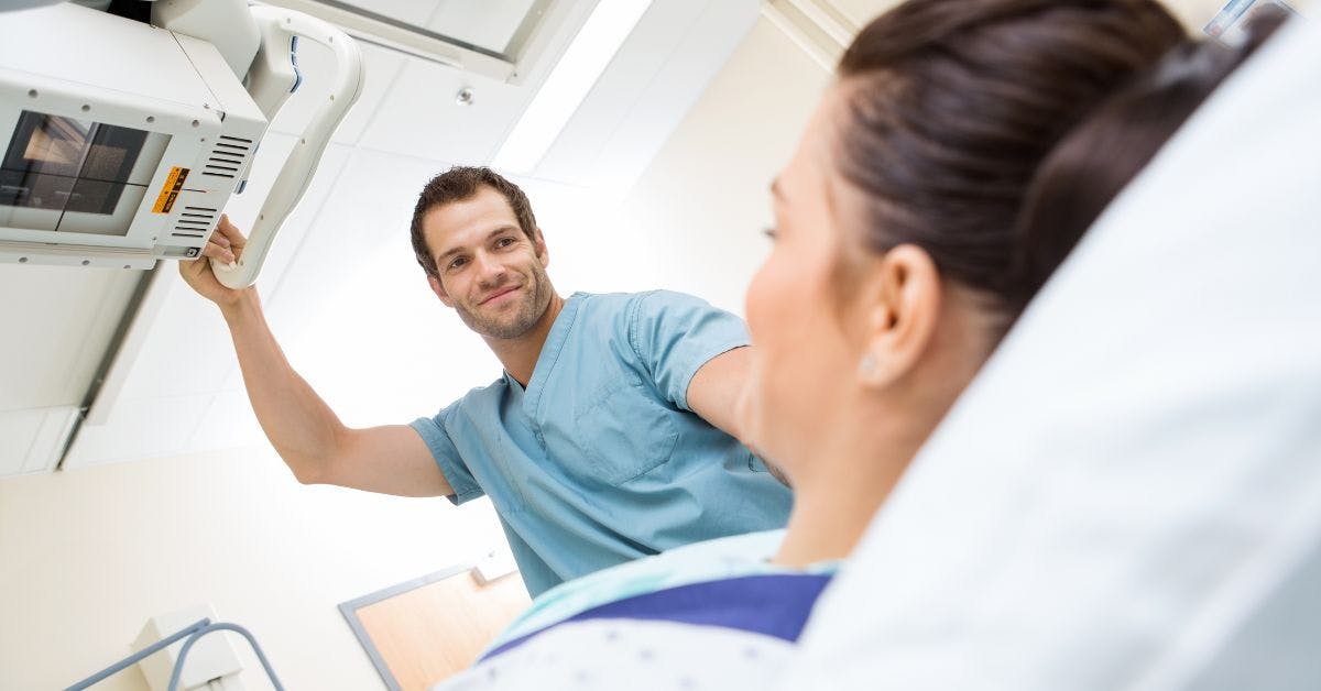 nurse adjusting xray machine for patient