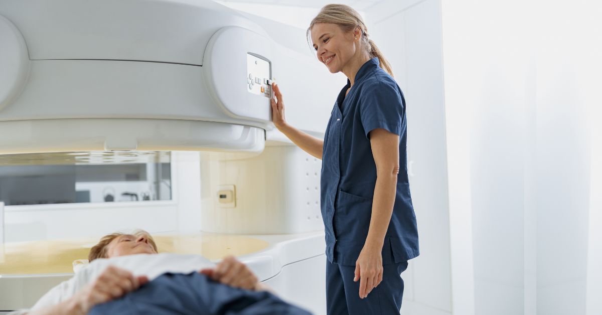 Radiologist controls MRI or CT Scan with patient undergoing procedure