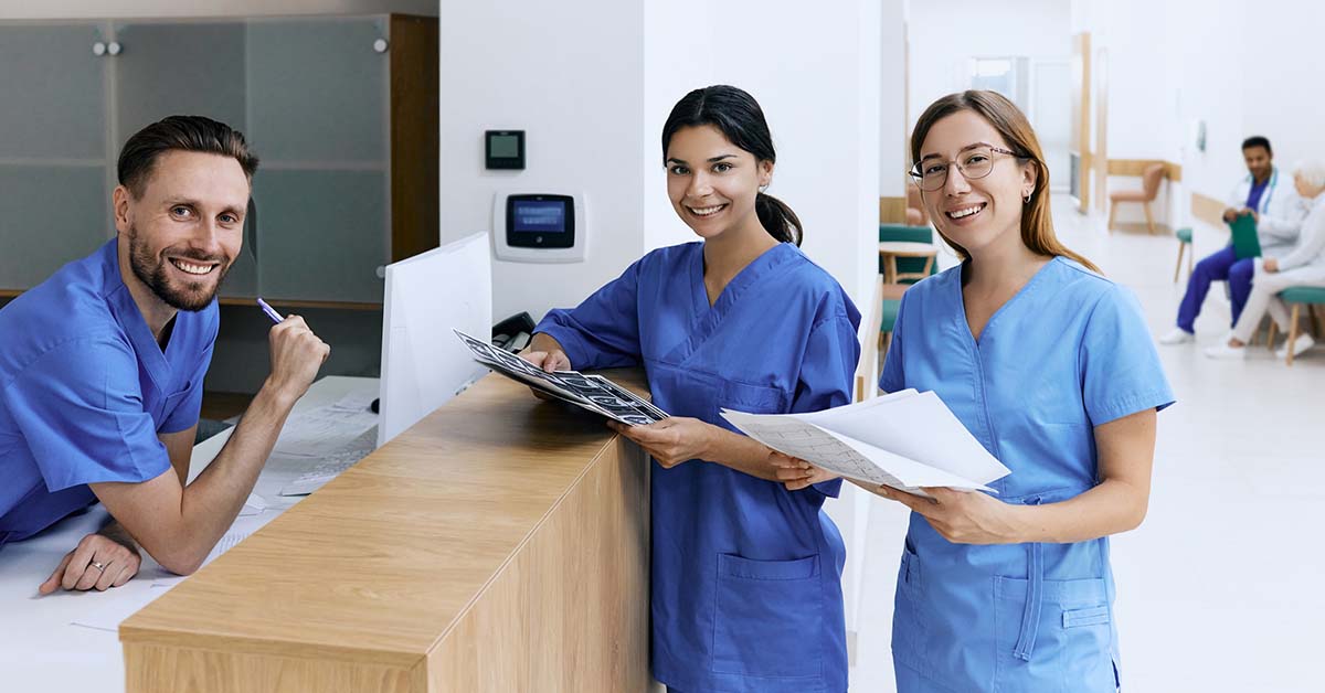 Receptionist talking with medical assistants