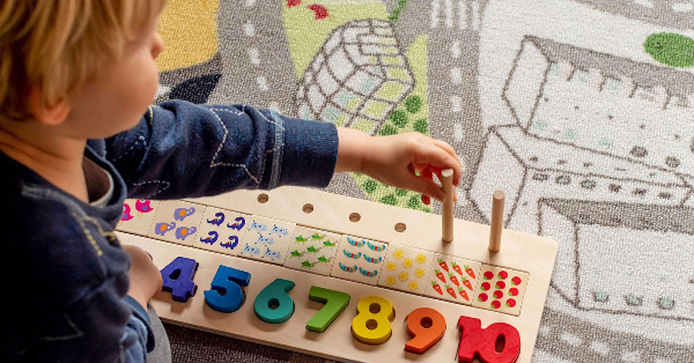Child playing with a toy, learning numbers