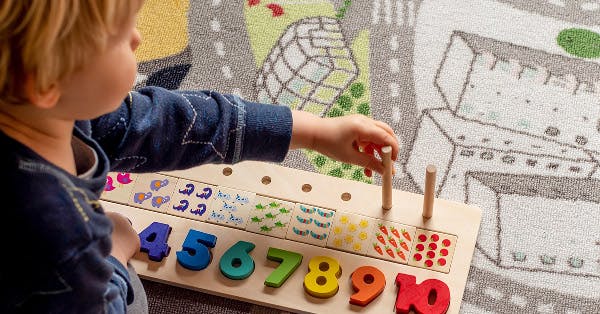 Child playing with a toy, learning numbers