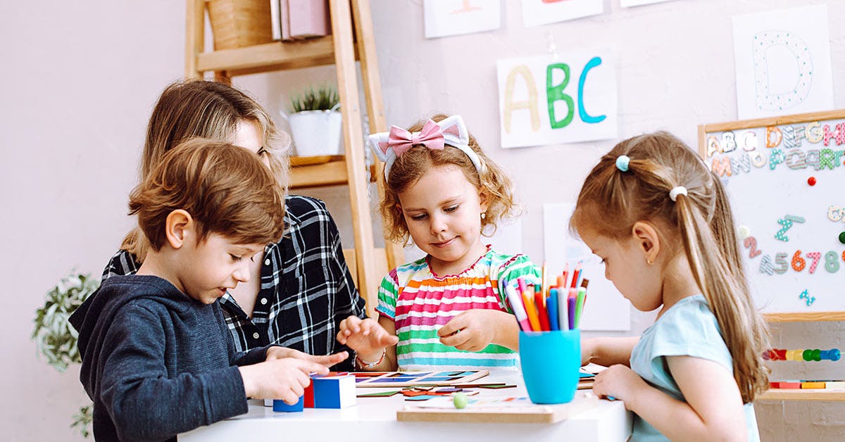 Children in childcare doing activities on a table