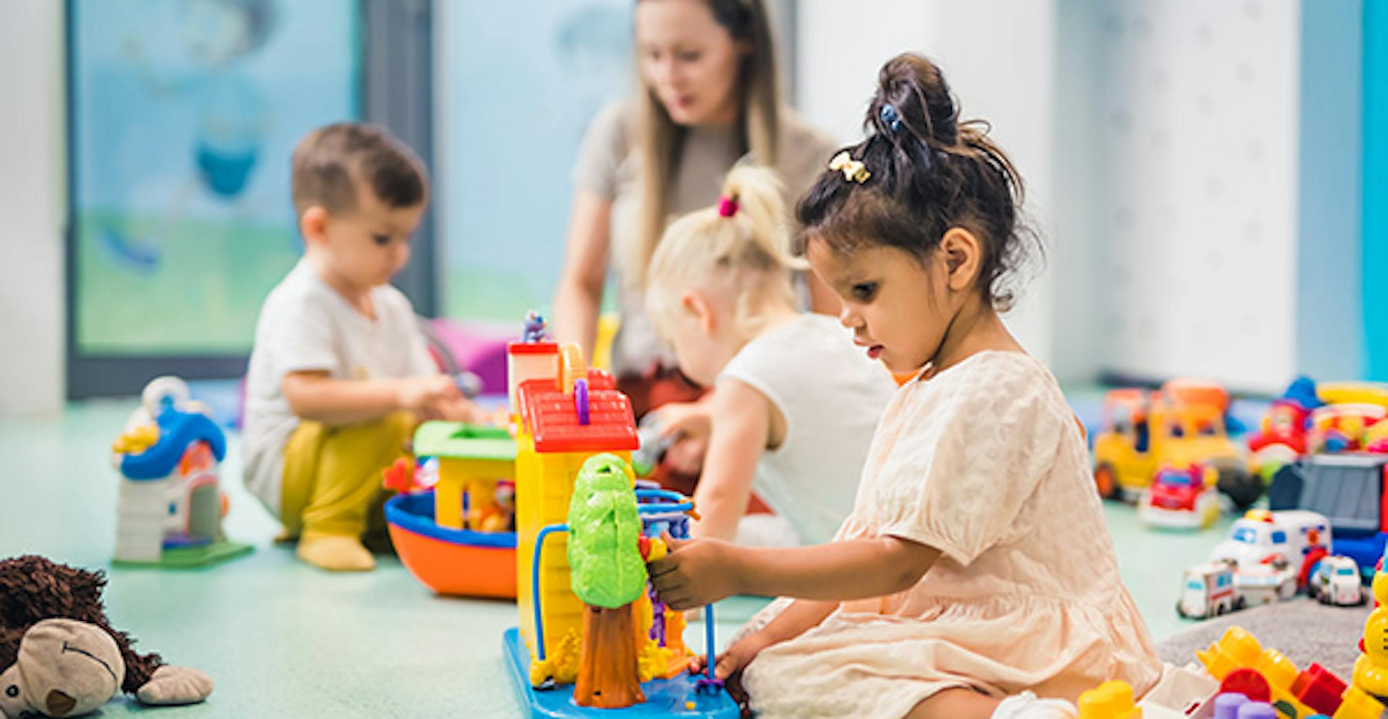 Girl toddler playing with kids toys
