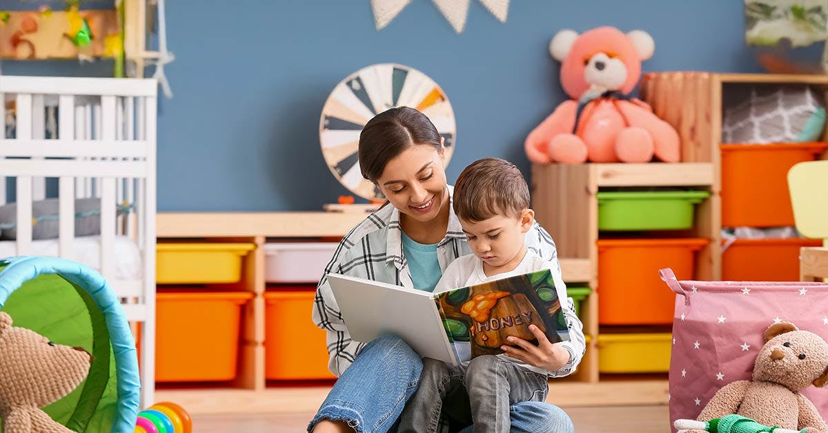 Early Childhood educator reading to a student