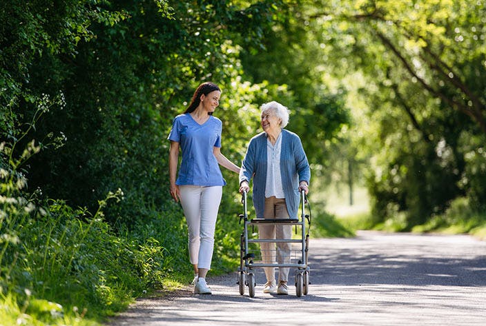 Student walking with elderly women