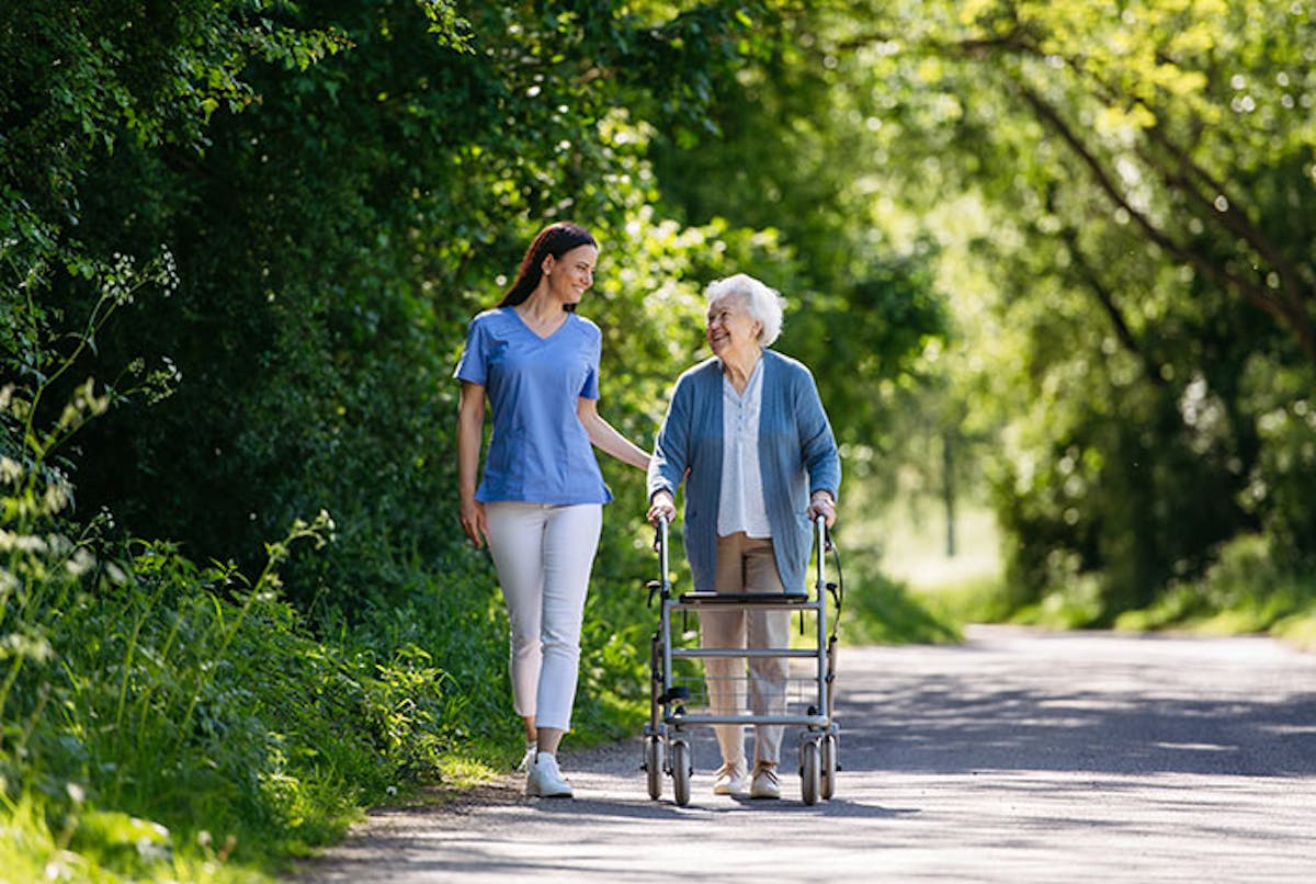 Student walking with elderly women