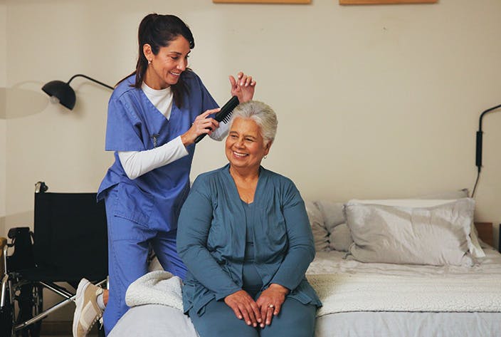 women brushing elderly ladies hair 2