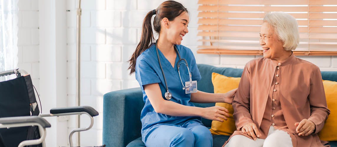 Aged care support worker providing care and reassurance to an older person.