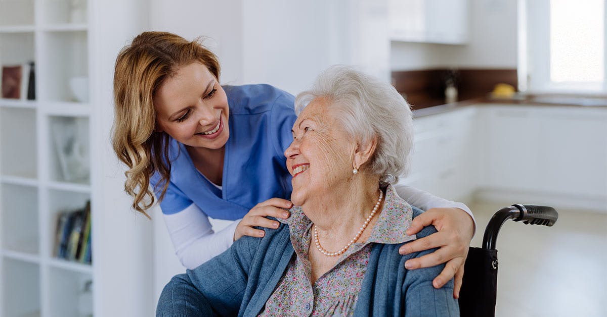 Allied health assistant supporting an older person using a wheelchair