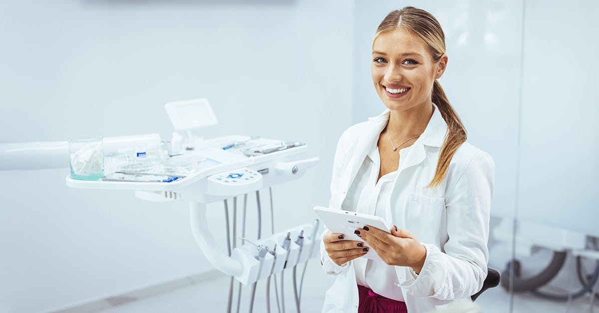 Dental assistant holding a tablet in a dental clinic