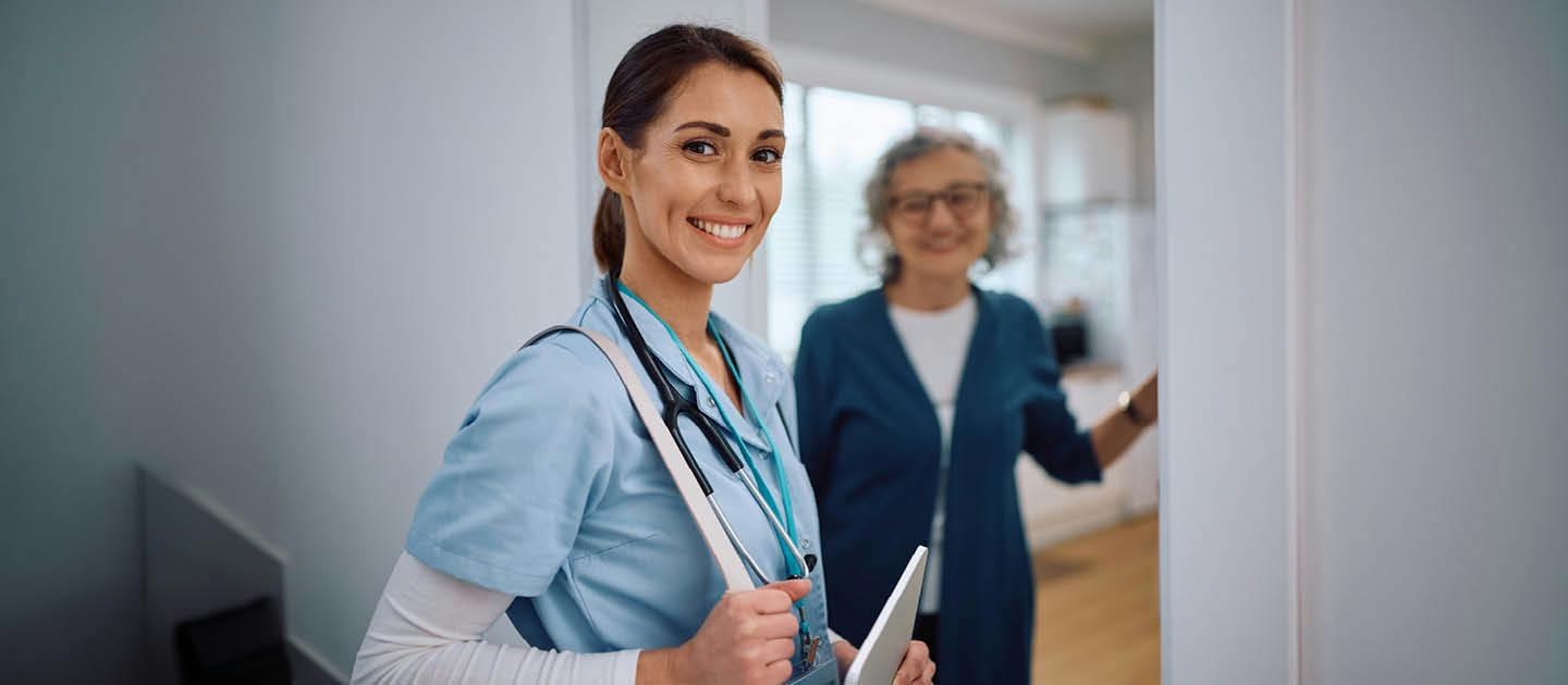 Support worker visiting an older woman in her home to provide care and assistance