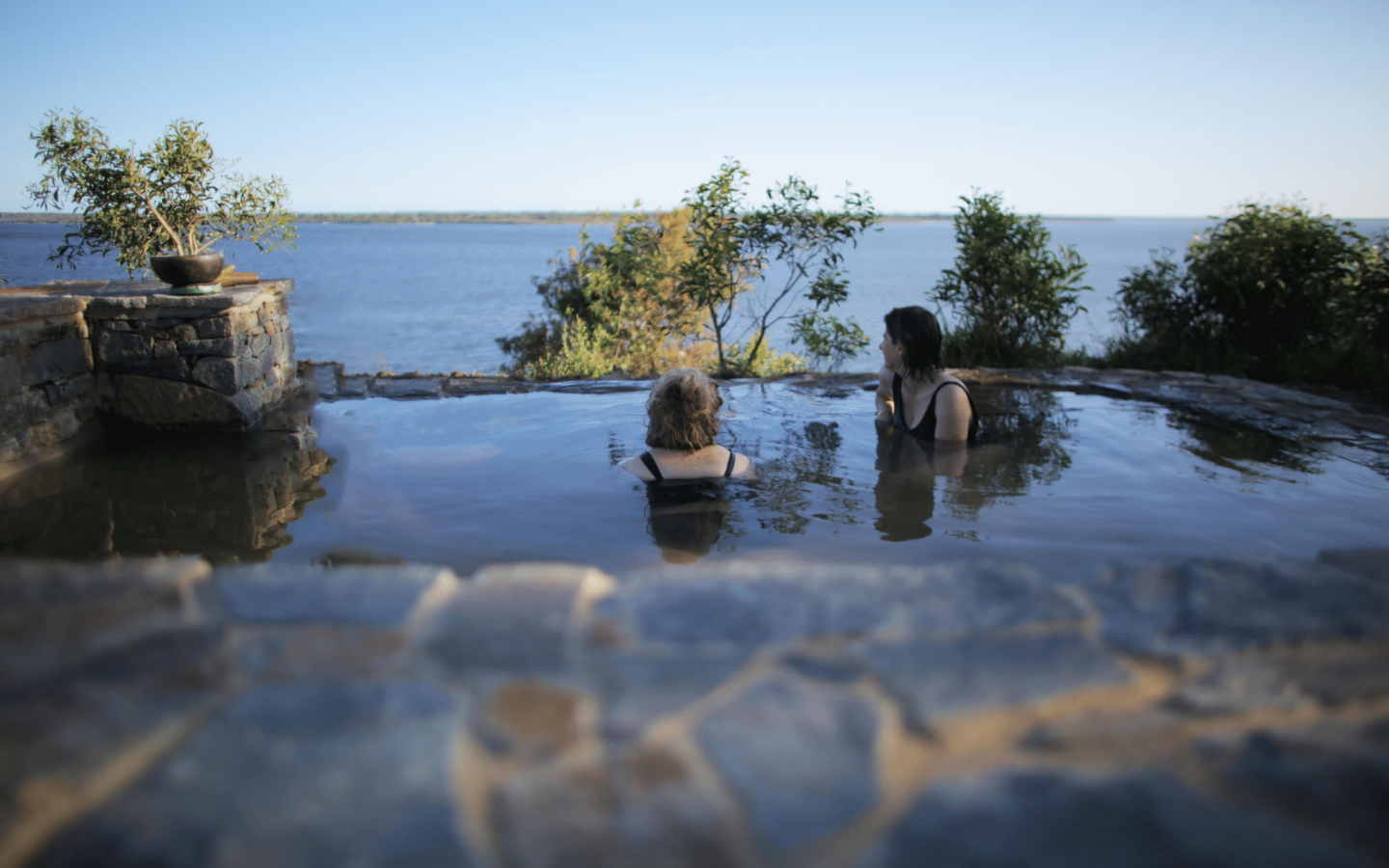 two girls soaking in geothermal waters