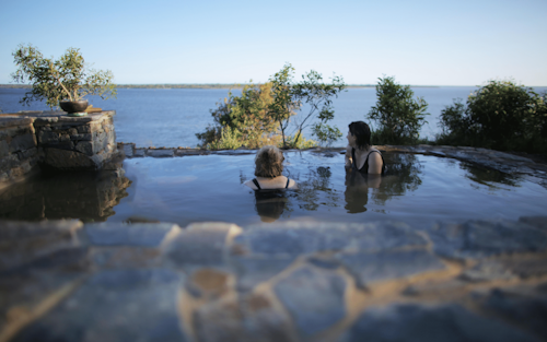 two girls soaking in geothermal waters