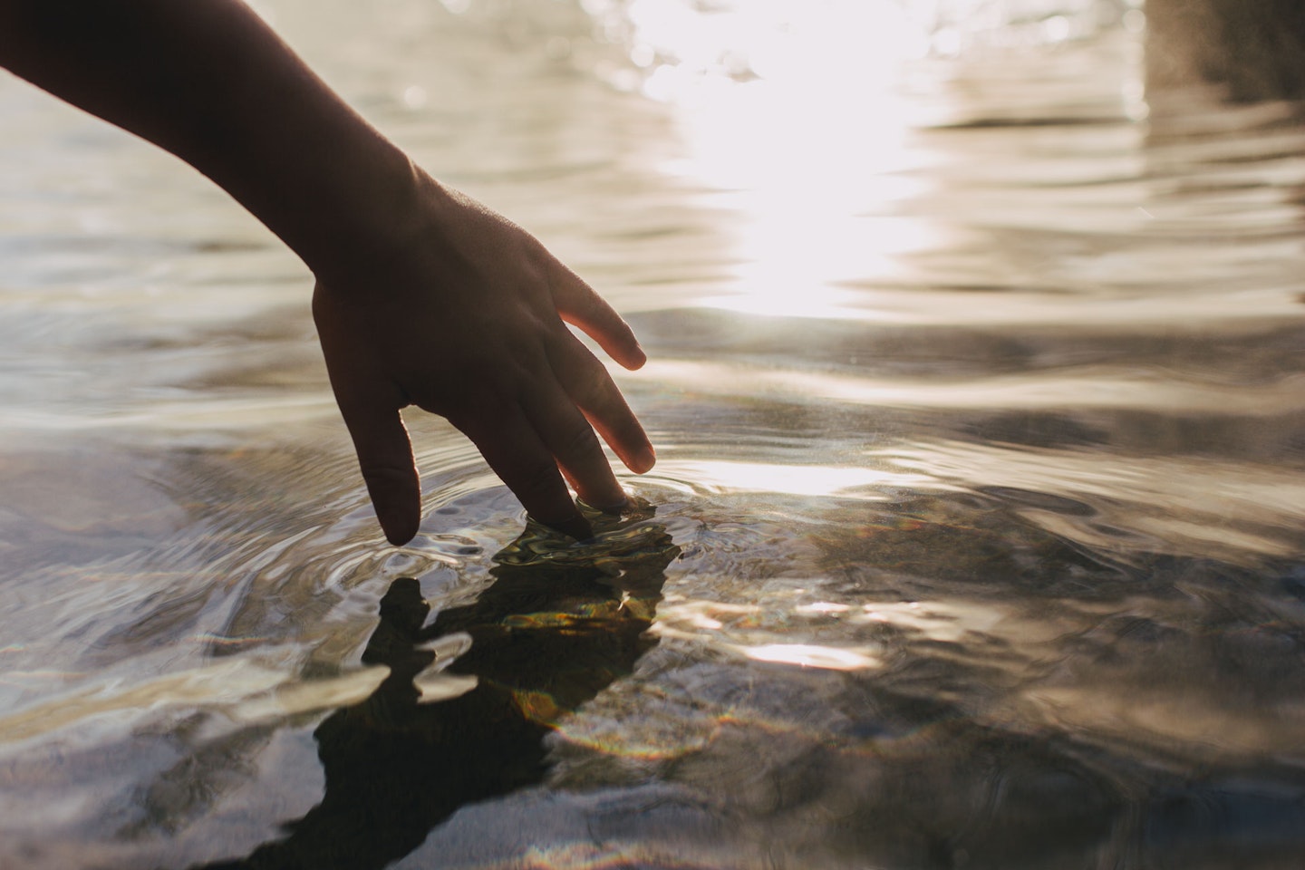 hand skimming water