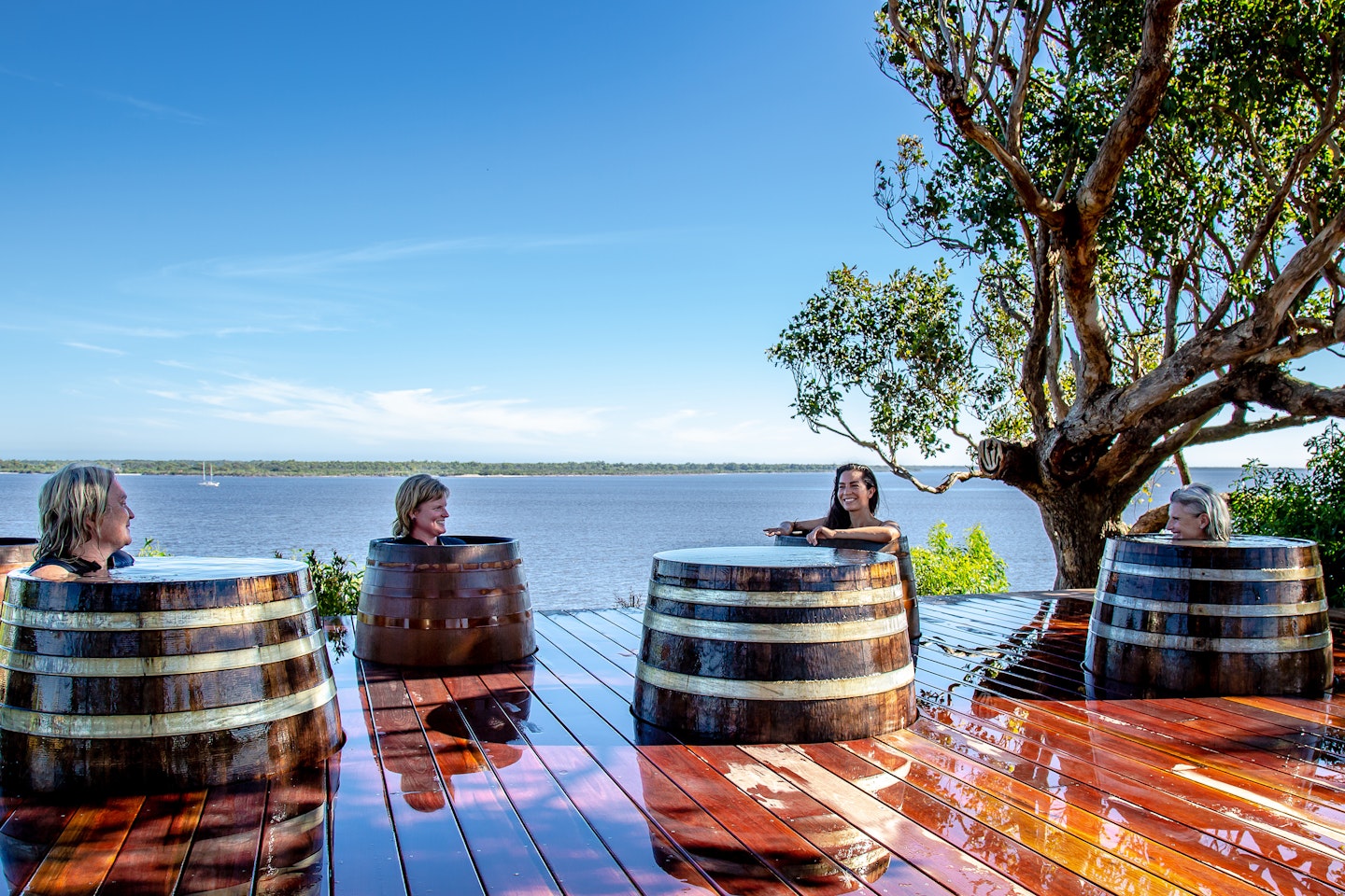 women bathing in geothermal hot springs barrels at metung hot springs gippsland lakes