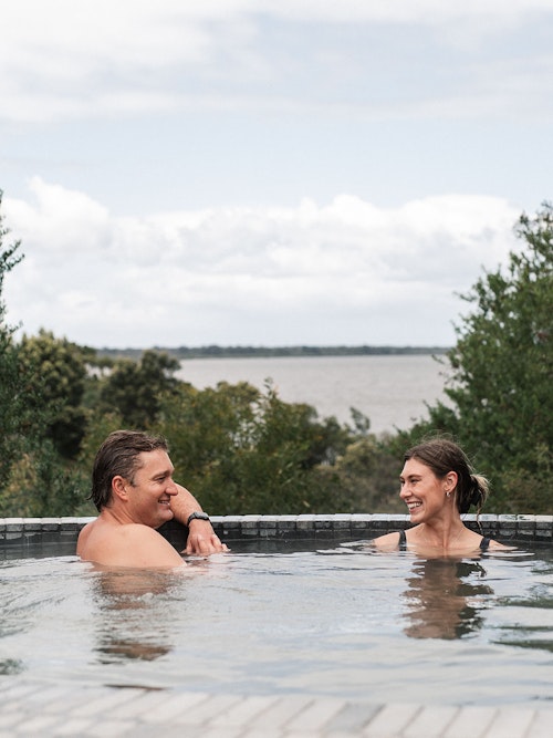 man and woman bathing in geothermal hot springs