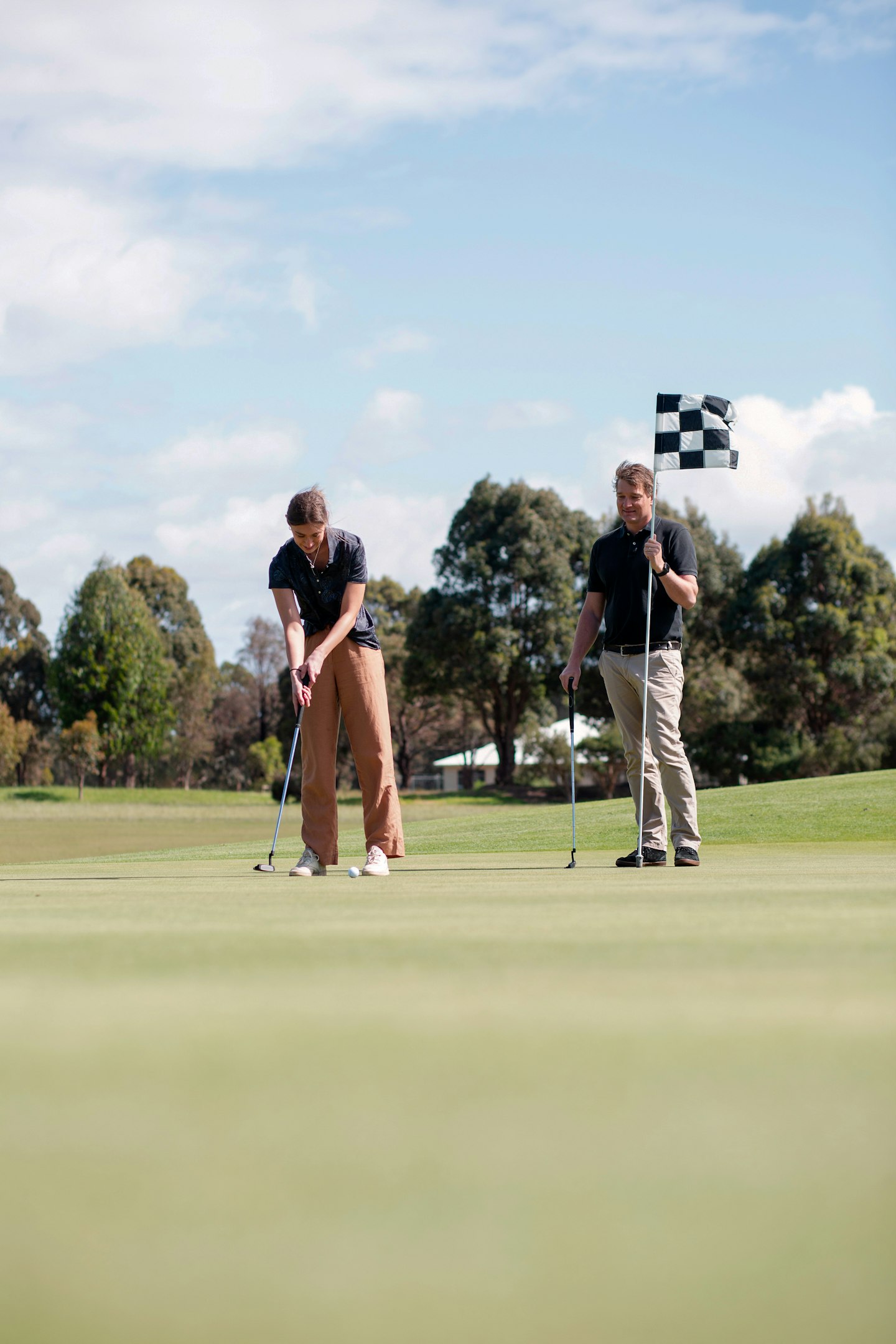 woman playing golf with man