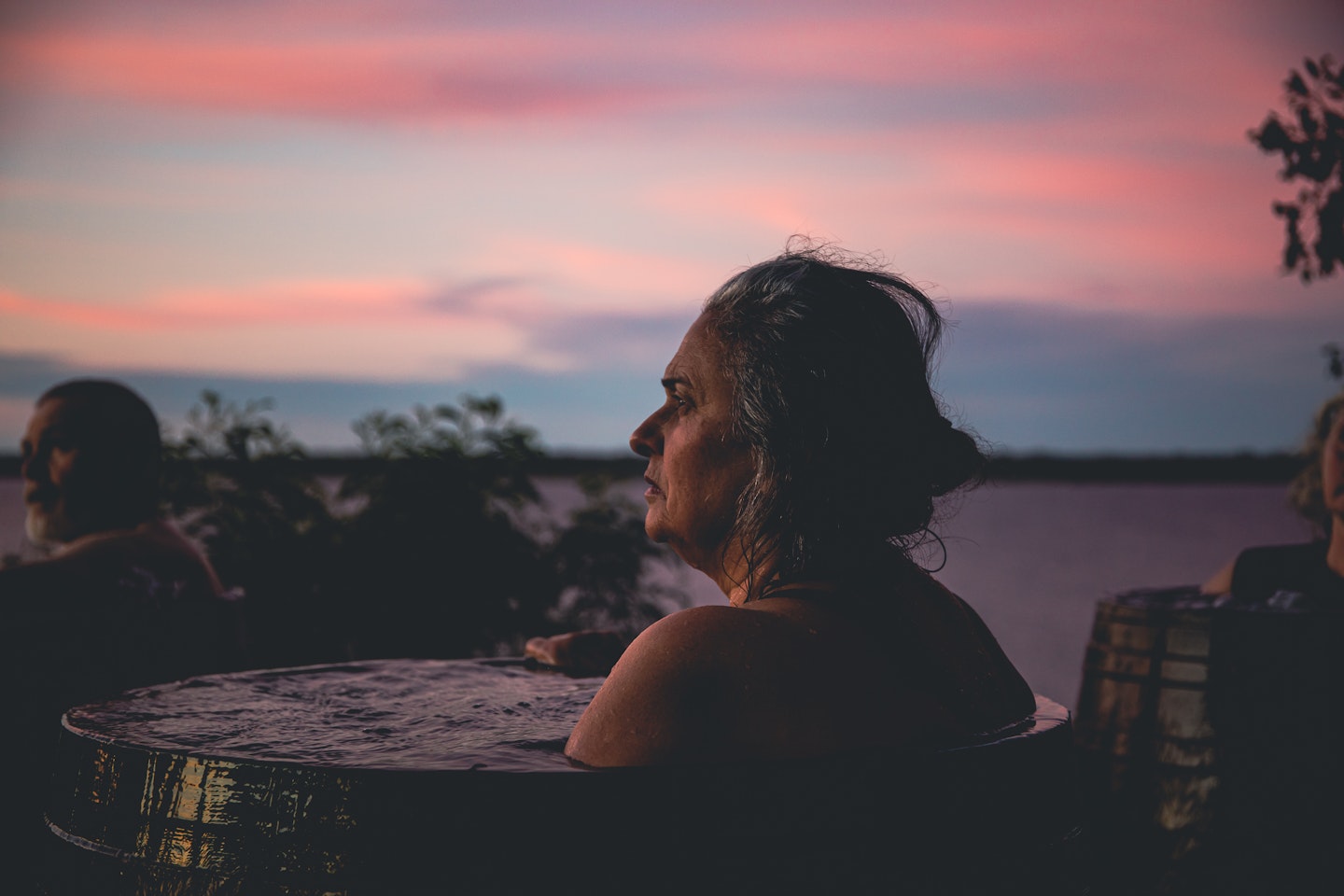 elderly lady bathing at metung hot springs at sunrise