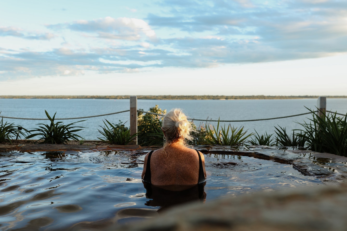 woman admiring gippsland lakes views from metung hot springs