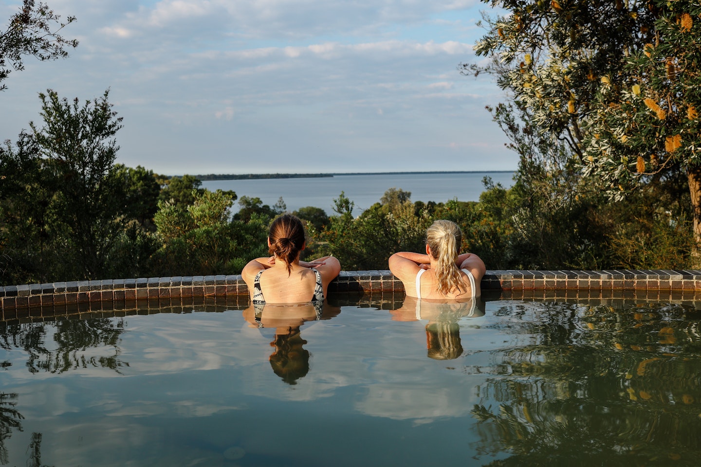 two ladies in the bathing ridge hillview pool overlooking the gippsland lakes