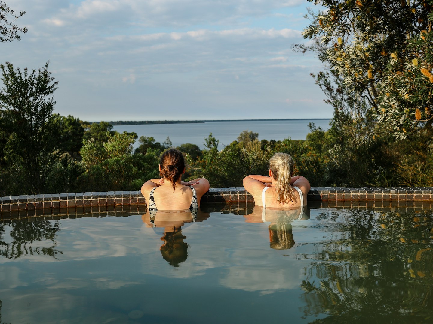 two ladies in the bathing ridge hillview pool overlooking the gippsland lakes