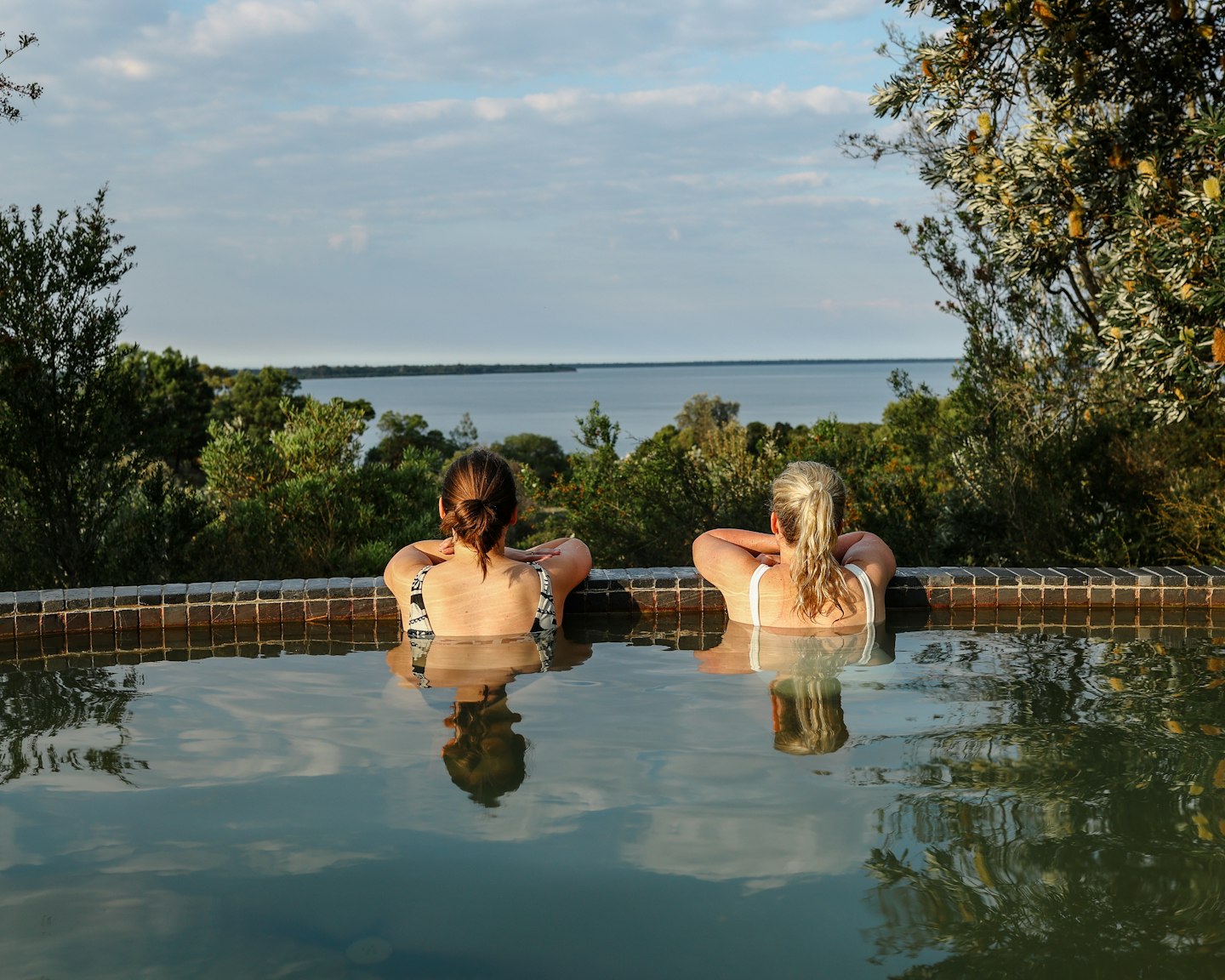 two ladies in the bathing ridge hillview pool overlooking the gippsland lakes