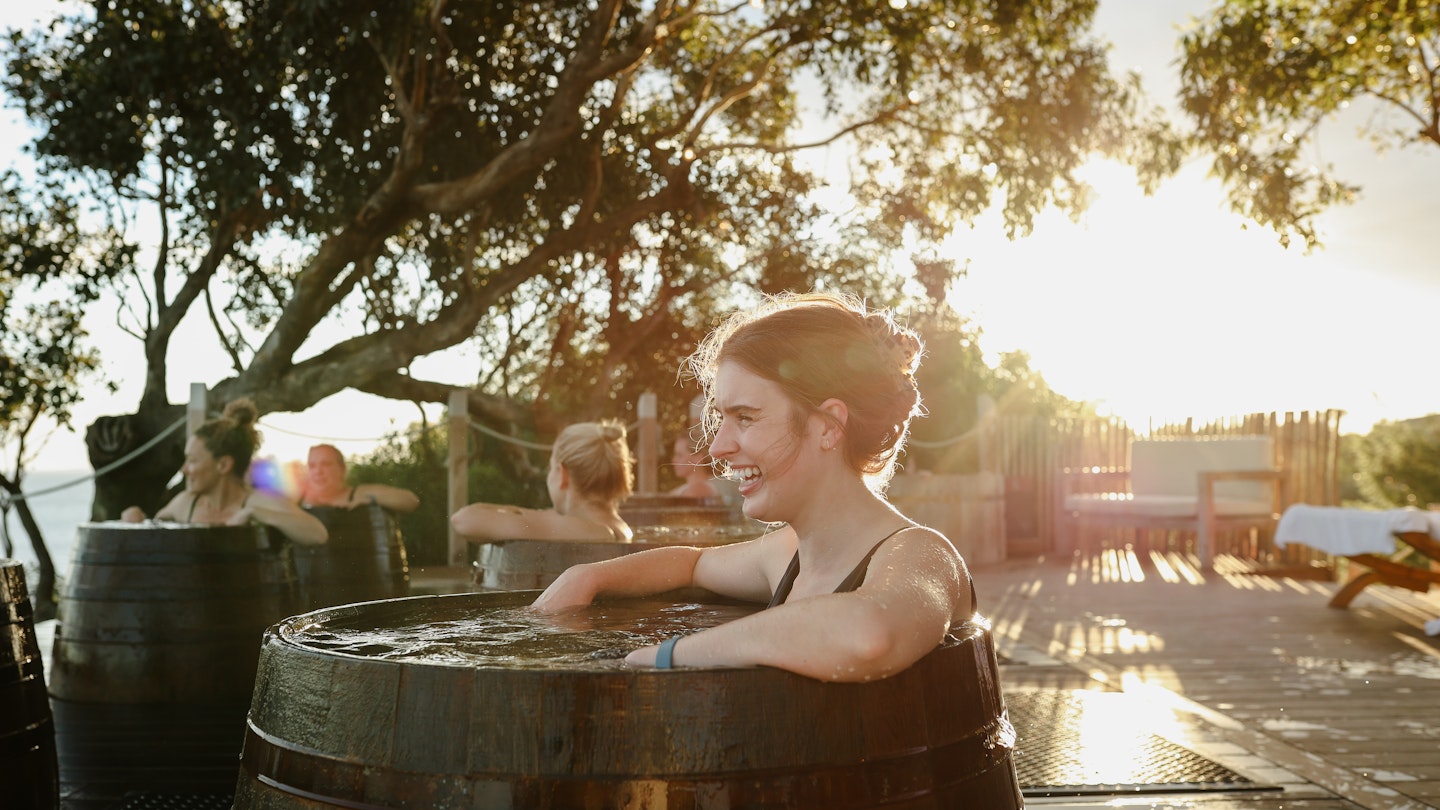 woman bathing in bathing barrel
