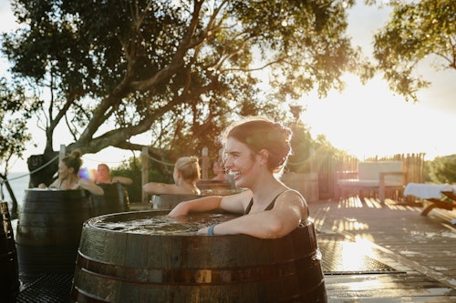 woman bathing in bathing barrel