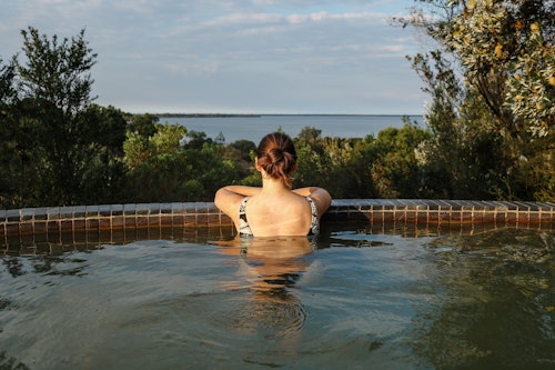 woman bathing at metung hot springs