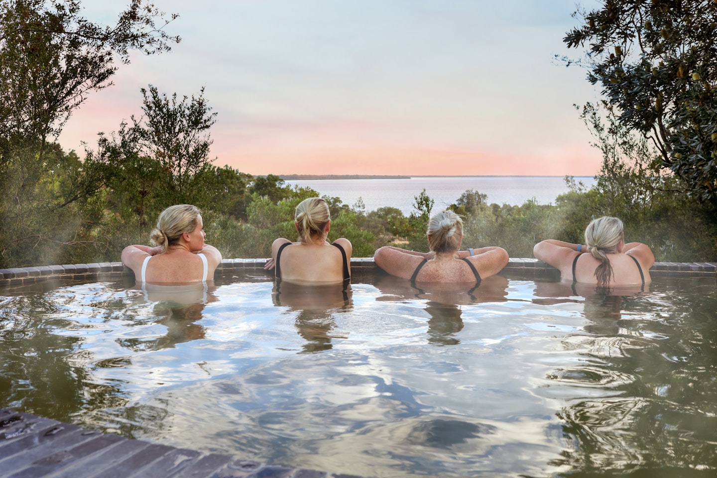 women bathing in hot springs