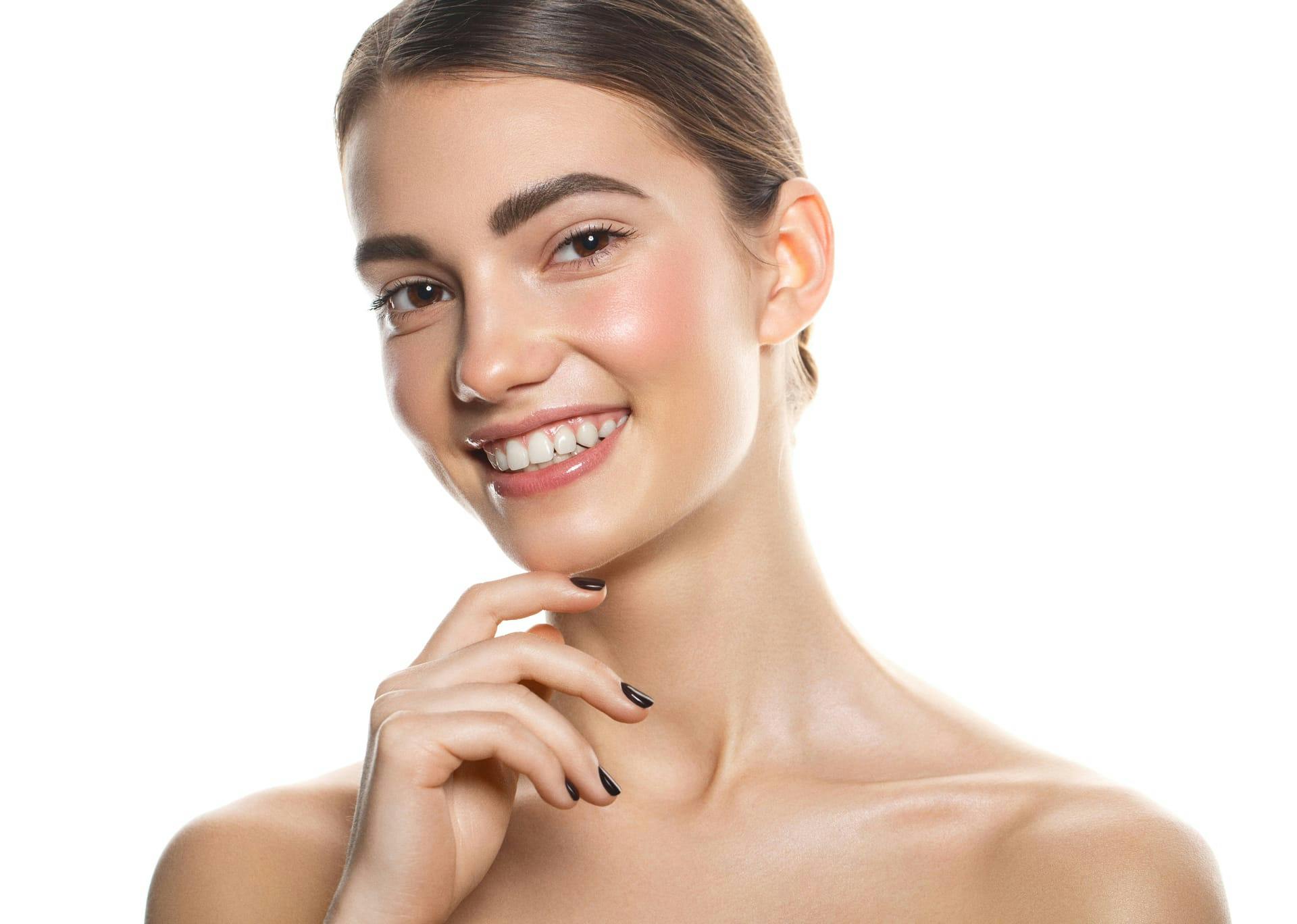 Woman smiling with brighter and tightened skin from vampire facial