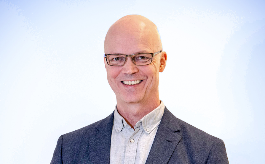 Portrett av Bjørn Helge Hoffmann i mørkegrå dress og lysegrå skjorte.