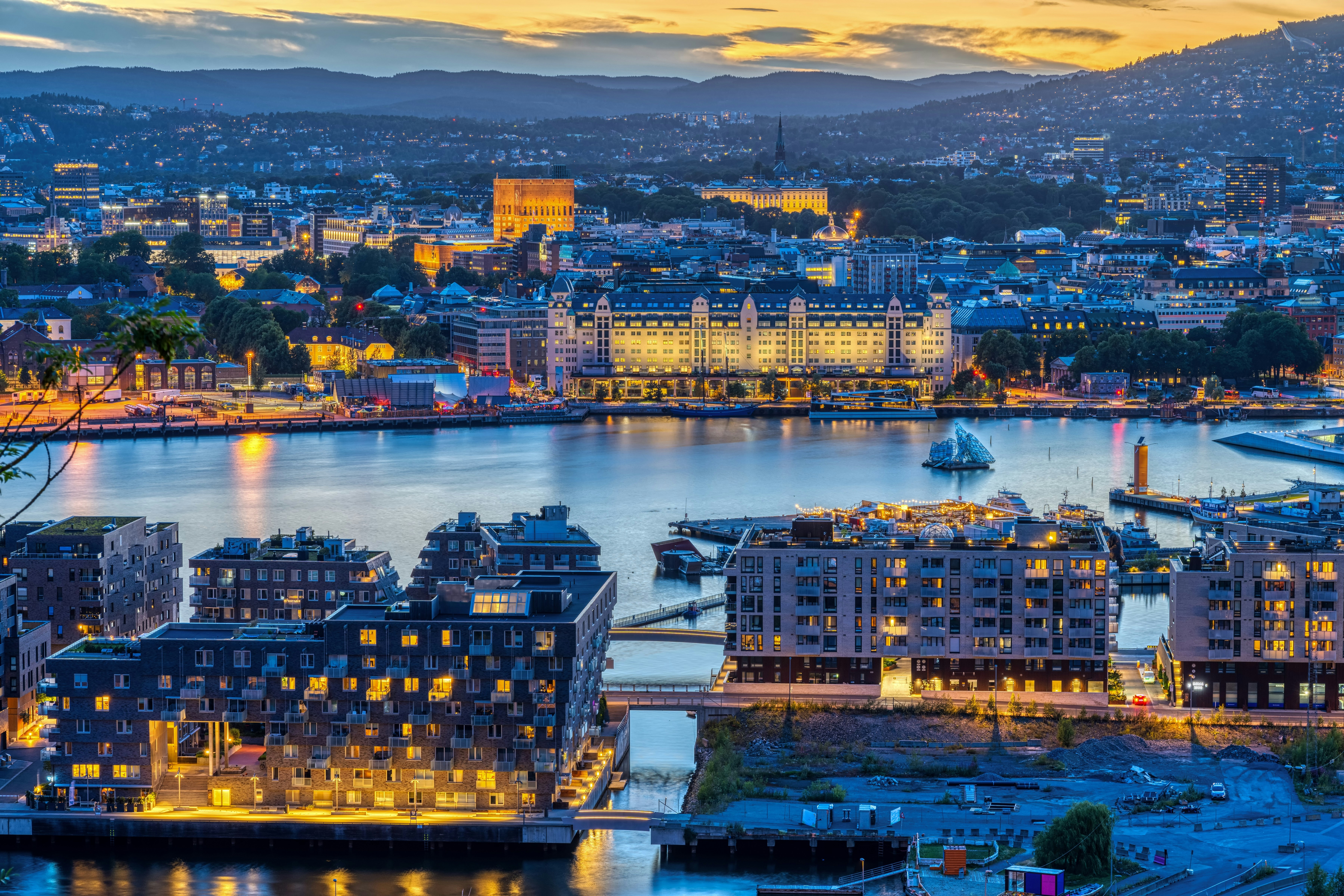 Flybilde av havna ved Bjørvika i Oslo en sommernatt.