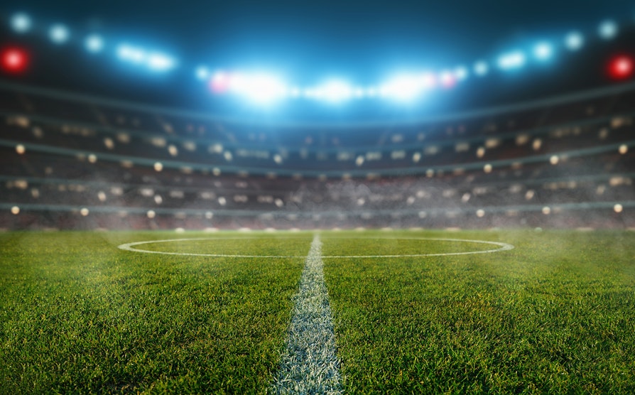 3D-illustrasjon av en opplyst fotballstadion.