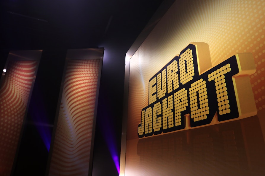 Bide fra Eurojackpots trekningsstudio i Finland. Bilde av vegg med logo.
