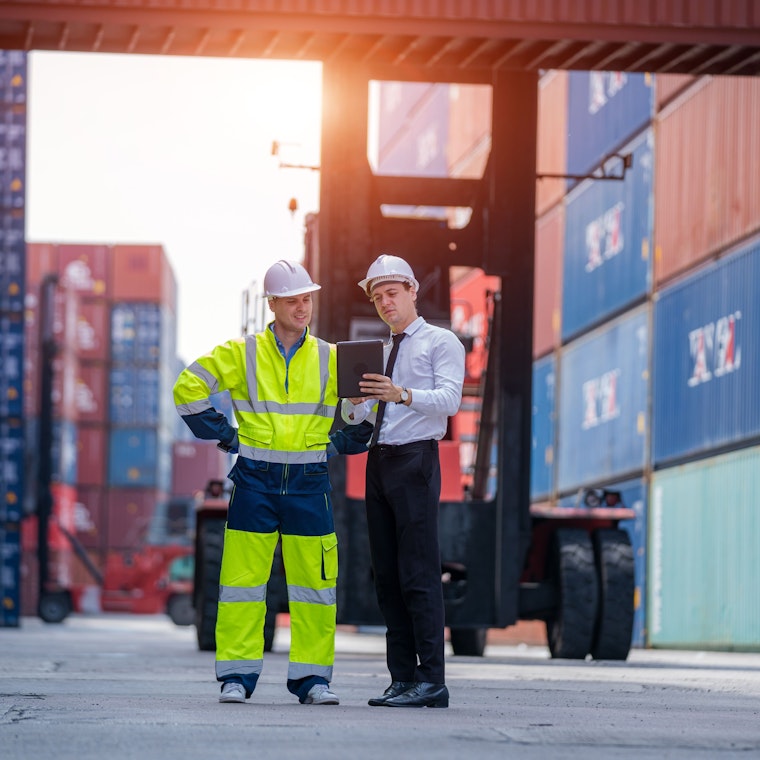 Een ingenieur met een arbeider die de voorraad in de container controleert voor laden, logistiek en bedrijfsexport.
