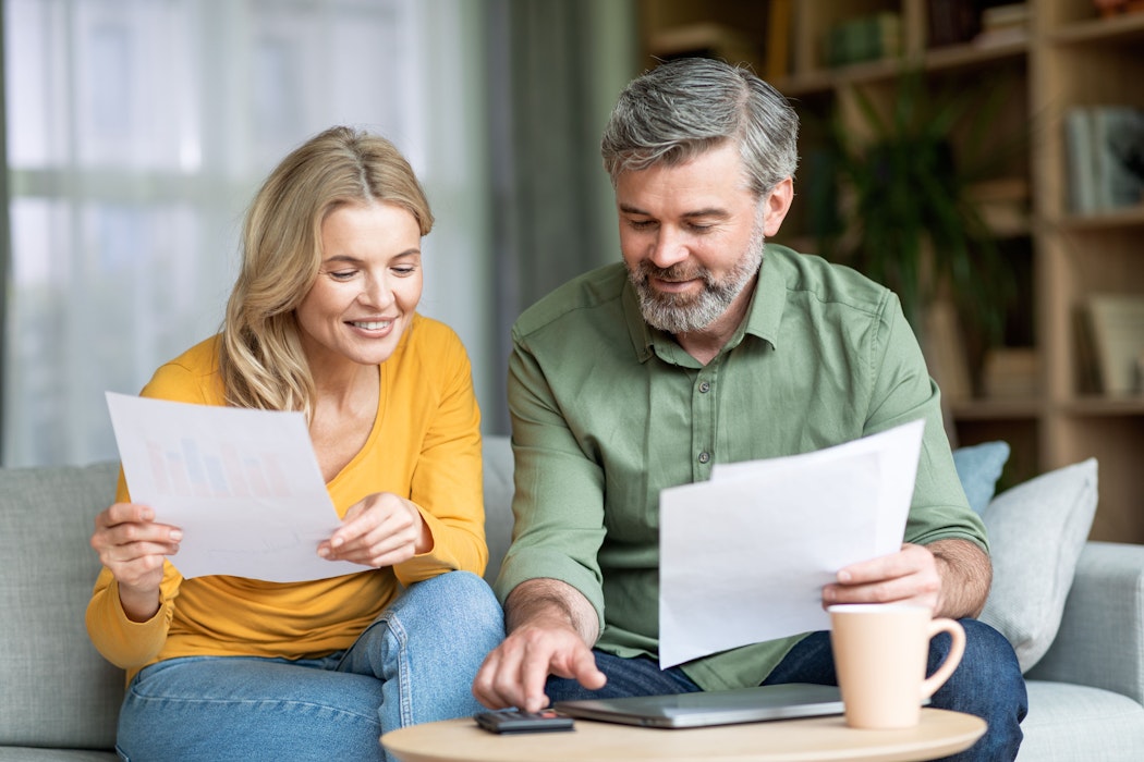 Echtgenoten controleren financiële documenten terwijl ze thuis het gezinsbudget plannen