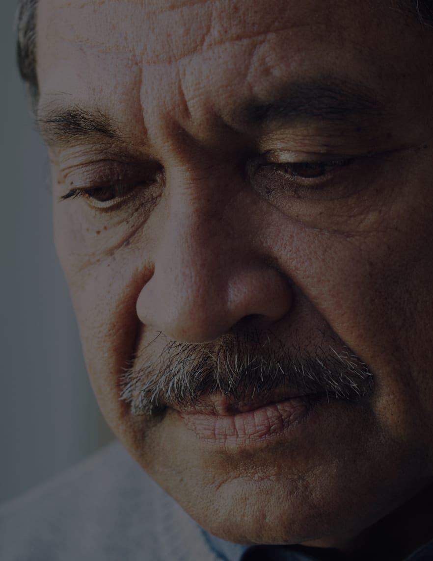 Senior citizen looking down.