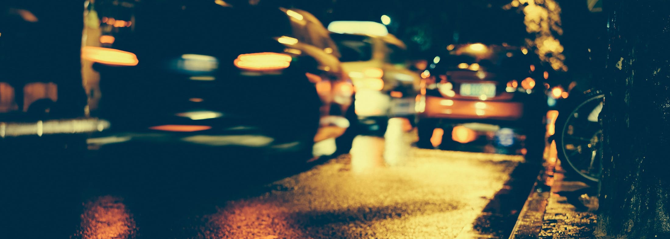 Blurry photo of a car passing at night