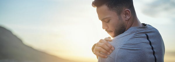 Man holding his shoulder