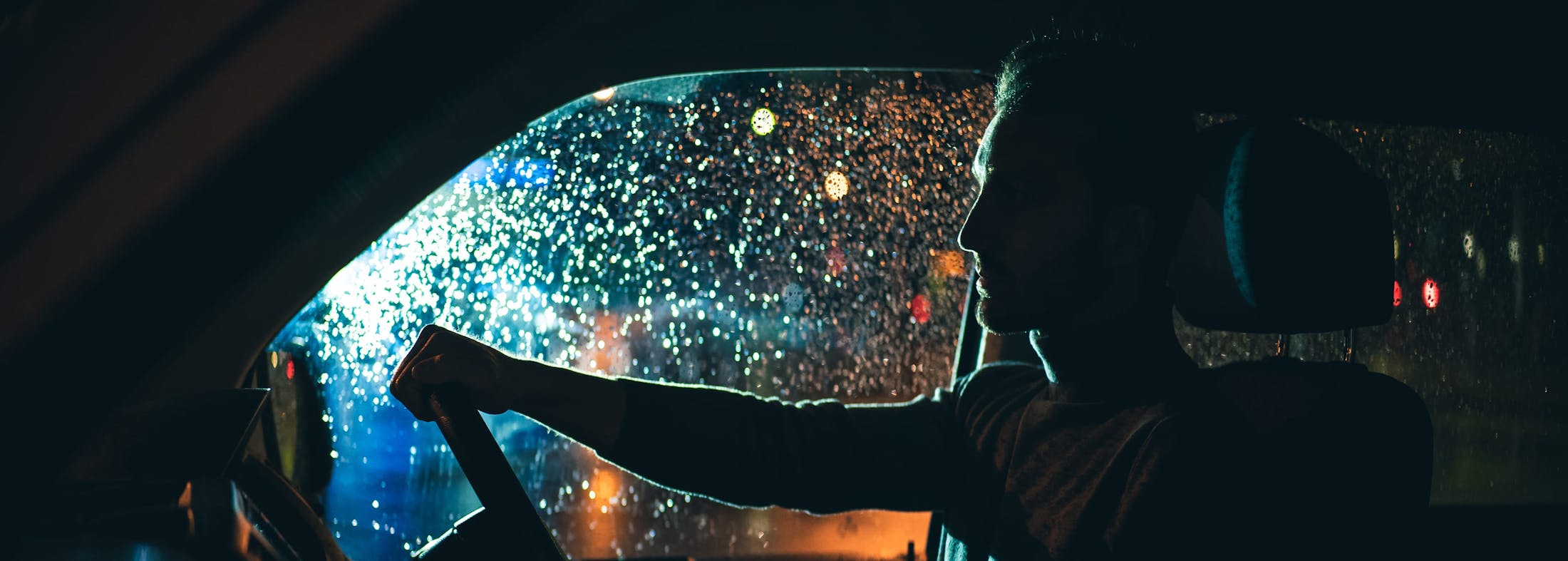 Man behind the wheel at night