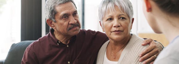 Worried elderly couple