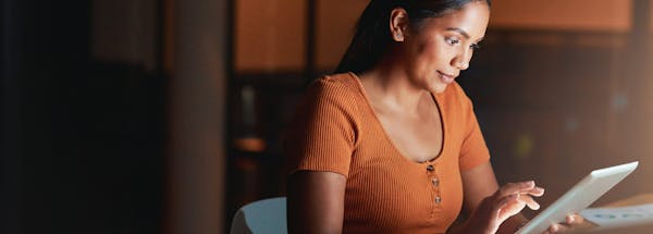 Woman reading her tablet
