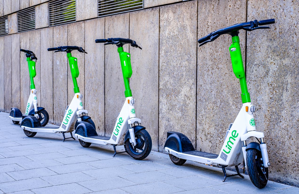 Lime scooters on a sidewalk
