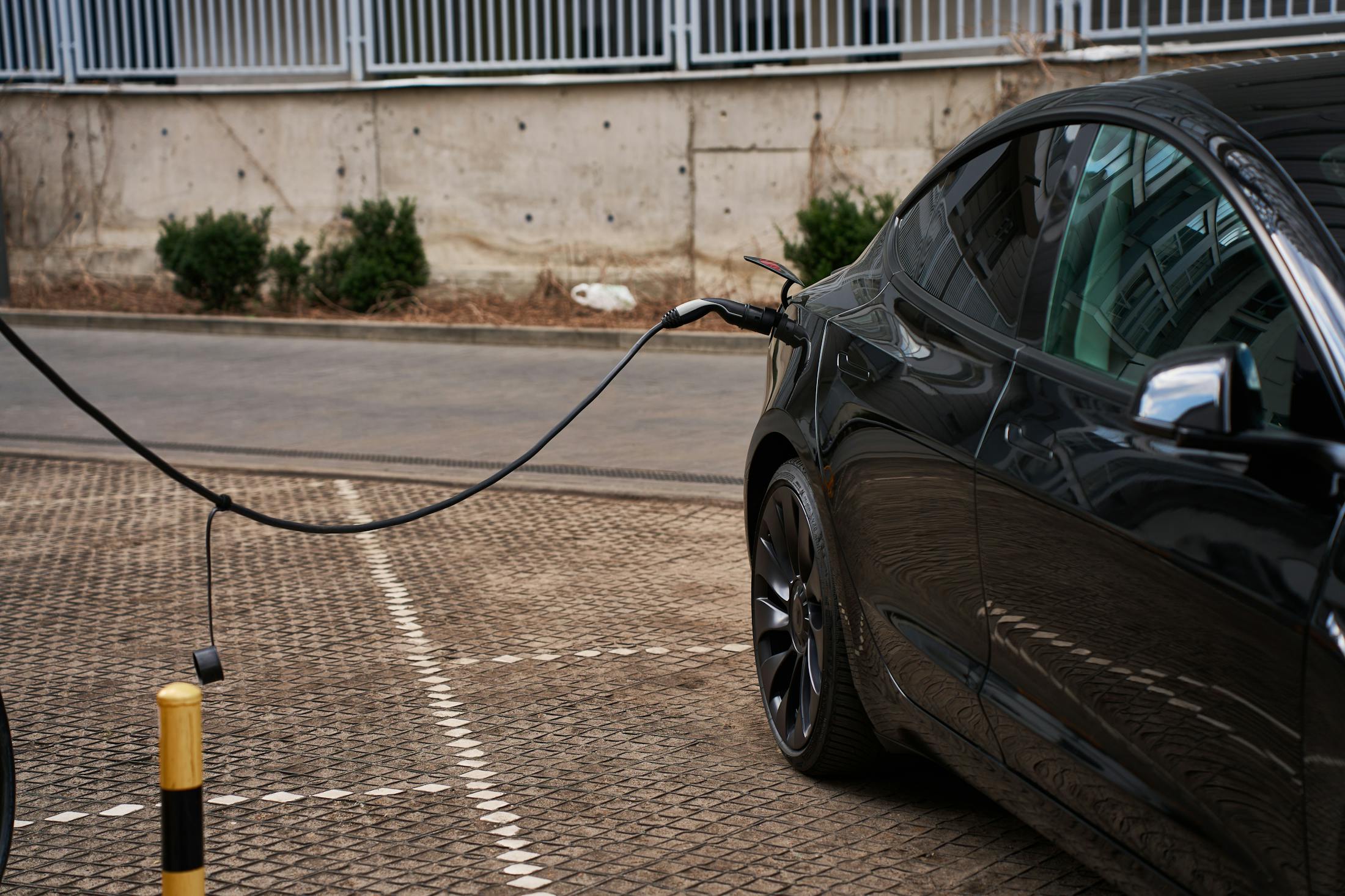 Tesla electric vehicle plugged into a charging station