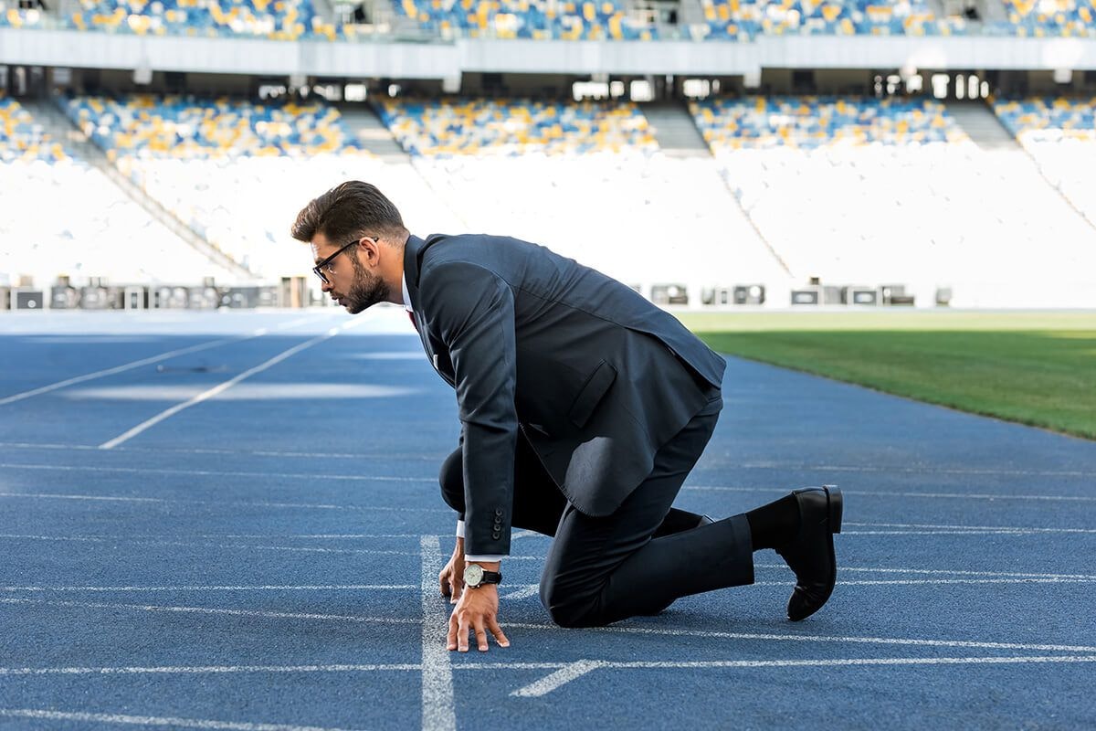 There’s More to Finding ‘Alpha’ Than Strategic Investments A businessman at the track, dressed in a suit ready to race